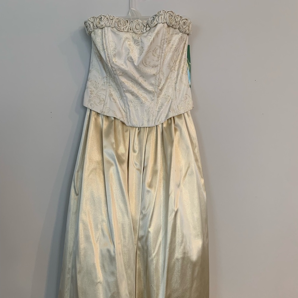 Size 12 sleeveless gown. Gold with rosettes around the top of the bodice.
